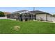 A beautiful backyard with a screened pool and plenty of green grass at 26115 Rampart Blvd, Punta Gorda, FL 33983