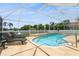 Inviting screened-in pool with lounge chairs and lush landscaping for a relaxing outdoor oasis at 26115 Rampart Blvd, Punta Gorda, FL 33983