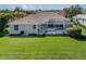 The residence features a screened-in pool and lush green lawn at 2928 Seasons Blvd, Sarasota, FL 34240