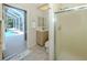 Bathroom featuring neutral finishes, walk-in shower, and view to private pool and lanai at 2928 Seasons Blvd, Sarasota, FL 34240