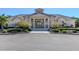 Well-maintained community clubhouse with an inviting entrance and manicured landscaping at 2928 Seasons Blvd, Sarasota, FL 34240