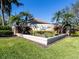 Landscaped entrance to Laurel Lakes community with mature tropical landscaping and a decorative sign at 2928 Seasons Blvd, Sarasota, FL 34240