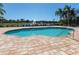 Community pool with fountain and lake views creates a tranquil atmosphere at 2928 Seasons Blvd, Sarasota, FL 34240