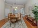 Bright dining room featuring wood floors, a chandelier, and open access to other living spaces at 2928 Seasons Blvd, Sarasota, FL 34240