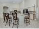 Bright kitchen featuring counter seating, tile backsplash, and stainless steel appliances at 2928 Seasons Blvd, Sarasota, FL 34240