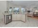 Open kitchen featuring stainless steel dishwasher and sink overlooking living area at 2928 Seasons Blvd, Sarasota, FL 34240