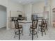 Bright kitchen featuring counter seating, tile backsplash, and stainless steel appliances at 2928 Seasons Blvd, Sarasota, FL 34240
