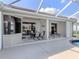 Covered lanai features ceiling fan, outdoor dining set, and sliding door access at 2928 Seasons Blvd, Sarasota, FL 34240