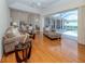 Open living room with slider to screened patio and pool, adjoining the kitchen and dining area at 2928 Seasons Blvd, Sarasota, FL 34240