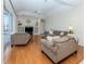 Open-concept living room with ceiling fan, hardwood floors and backyard views at 2928 Seasons Blvd, Sarasota, FL 34240