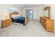 Comfortable main bedroom with an ensuite bathroom, carpeted floors and lanai access at 2928 Seasons Blvd, Sarasota, FL 34240