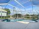 The pool is screen-enclosed and features a heated spa with a waterfall feature at 2928 Seasons Blvd, Sarasota, FL 34240