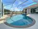 Screened-in pool featuring heated spa with a waterfall feature and water views at 2928 Seasons Blvd, Sarasota, FL 34240