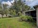 Spacious backyard with lush green grass, mature trees, and a fenced perimeter at 3139 Point St, North Port, FL 34286