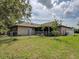 Backyard featuring a chain-link fence, green grass, and partial views of the home's exterior at 3139 Point St, North Port, FL 34286