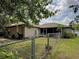 Spacious backyard with mature trees, chain-link fence, and partial view of the home's screened porch at 3139 Point St, North Port, FL 34286