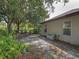 Backyard featuring a side yard area, lush greenery, and partial view of the home's exterior at 3139 Point St, North Port, FL 34286