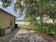 A spacious backyard with mature trees and partial fencing offers a serene outdoor living space at 3139 Point St, North Port, FL 34286