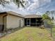 View of the home's exterior and backyard with lanai and lush lawn at 3139 Point St, North Port, FL 34286