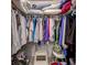 A walk-in closet showing hanging clothes, top shelf storage, and a step stool at 3139 Point St, North Port, FL 34286