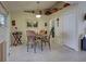 Cozy dining room with travertine floors, a decorative table and chairs, and ample natural light at 3139 Point St, North Port, FL 34286