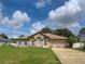 Well-maintained one-story home with a lush green lawn and a classic architectural design at 3139 Point St, North Port, FL 34286
