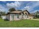 One-story home with manicured lawn, garden beds, and a charming facade at 3139 Point St, North Port, FL 34286