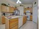 Bright kitchen features wood cabinets, tile backsplash, and stainless steel appliances at 3139 Point St, North Port, FL 34286