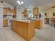 Spacious kitchen with central island, light wood cabinetry, and ample counter space at 3139 Point St, North Port, FL 34286