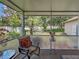 Relaxing screened lanai with comfortable seating and garden views at 3139 Point St, North Port, FL 34286