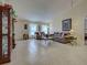 Comfortable living room features tile floors, natural light, and stylish furniture, perfect for relaxation and entertaining at 3139 Point St, North Port, FL 34286