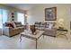 Well-lit living room featuring tile flooring, comfortable sofas, and tasteful décor creating a cozy atmosphere at 3139 Point St, North Port, FL 34286