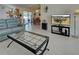 Open-concept living room featuring tile flooring, a decorative fireplace, and seamless access to the dining area at 3139 Point St, North Port, FL 34286