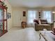 Comfortable living room with tile floors, neutral walls, and large windows with sheer curtains at 3139 Point St, North Port, FL 34286