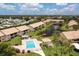 Aerial view of a community featuring a pool, pond, and well-maintained landscaping at 330 Mission N Trl # B, Venice, FL 34285