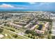Aerial view of community with mature landscaping, tranquil ponds, and golf course nearby at 330 Mission N Trl # B, Venice, FL 34285