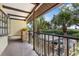 Balcony view with iron railing, outdoor plants, and views of the covered parking and community greenery at 330 Mission N Trl # B, Venice, FL 34285