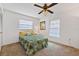 Well-lit bedroom with neutral walls and flooring, bright windows, and a comfortable bed at 330 Mission N Trl # B, Venice, FL 34285