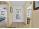 Condo foyer featuring tile floor and views of living room and kitchen, creating a bright and welcoming space at 330 Mission N Trl # B, Venice, FL 34285