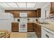 The kitchen showcases wooden cabinets, white appliances, and a practical layout at 330 Mission N Trl # B, Venice, FL 34285