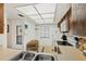 Well-lit kitchen includes a dining area, white cabinets, and standard appliances at 330 Mission N Trl # B, Venice, FL 34285