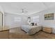 Bright main bedroom boasts ceiling fan, ample natural light, and neutral carpeting at 330 Mission N Trl # B, Venice, FL 34285