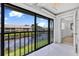 Enclosed patio with serene pond views and access to the main living space at 330 Mission N Trl # B, Venice, FL 34285