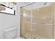 Shower with a glass door and tile surround at 330 Mission N Trl # B, Venice, FL 34285