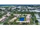 Aerial view of the community featuring a lake, pool, and tropical landscaping at 330 Mission N Trl # F, Venice, FL 34285