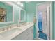 Bright bathroom with double sinks, modern fixtures, and a walk-in shower with stylish shower curtain at 330 Mission N Trl # F, Venice, FL 34285