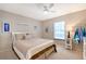 Cozy bedroom featuring stylish nautical decor, a ceiling fan and a window with natural light at 330 Mission N Trl # F, Venice, FL 34285