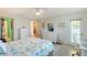 Bright bedroom with seaside-themed decor, a ceiling fan, and a door to the outside at 330 Mission N Trl # F, Venice, FL 34285