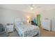 Bright bedroom with seaside-themed decor, comfortable seating, and plenty of storage space at 330 Mission N Trl # F, Venice, FL 34285