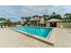 Community pool area with lounge chairs, palm trees and pool-side restrooms at 330 Mission N Trl # F, Venice, FL 34285